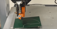 table top robot demonstration with ChoBond/Chomerics 1075
